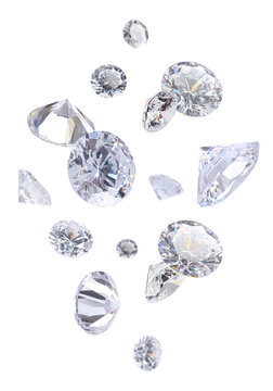 Beautiful shiny diamonds in air on white background