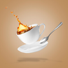 Cup of coffee, saucer and spoon in air on dark beige background