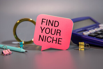 FIND YOUR NICHE. text on white paper on a gray background