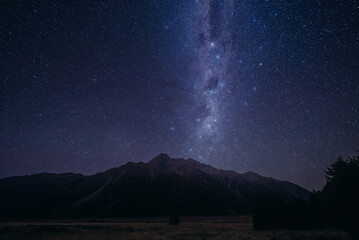 Starry Night Sky Above Mountain Range. The night sky is filled with countless stars shining above a...