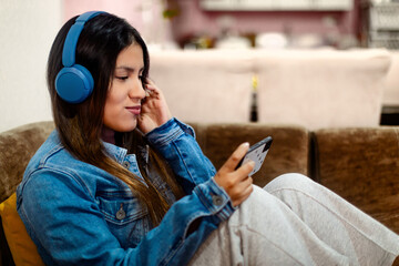 Listening to Music with Blue Headphones and Denim Jacket.copyspace