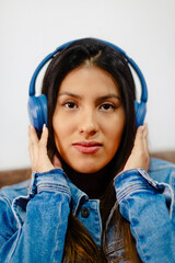 Listening to Music with Blue Headphones and Denim Jacket