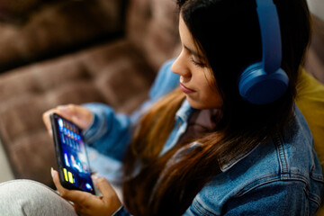Happy Woman Immersed in Mobile Entertainment with Blue Headphones. copyspace