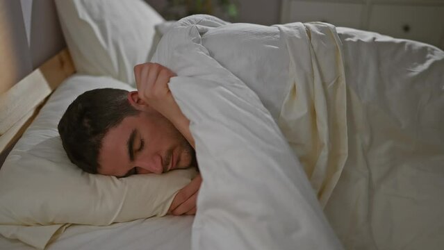A young hispanic man peacefully sleeping in a cozy bedroom, encapsulating tranquility and restfulness.