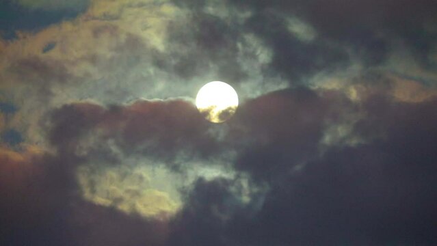 NORMAL SPEED VIDEO OF DRAMATIC NIGHT SKY WITH FULL MOON AMONG THE DARK CLOUDS