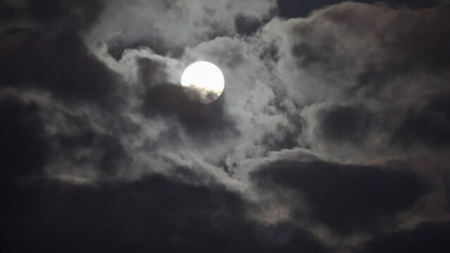 NORMAL SPEED VIDEO OF DRAMATIC NIGHT SKY WITH FULL MOON AMONG THE DARK CLOUDS