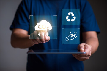 Reduce co2 emission. man using software to lower CO2 emissions to limit global warming and climate...