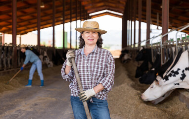 Portrait of mature farm owner in a cowshed
