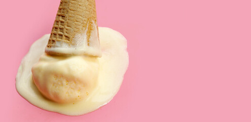 Melting ice cream balls with waffle cone on blue background.