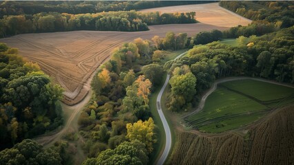 an aerial view of a winding road meandering through a lush landscape