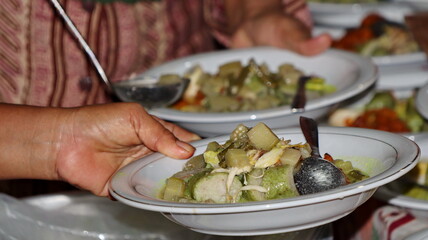Lontong Sayur, served with chicken, balado potatoes, vegetables lodeh eggplant coconut milk and crackers