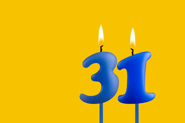 Blue candle number 31 - Birthday on yellow background