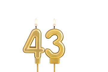 Golden number 43 birthday candle on white background
