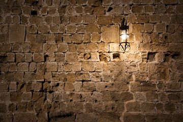 Dark brick wall background with an old lantern