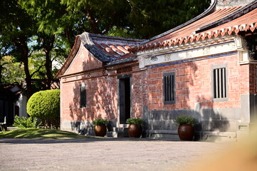 Fototapeta premium Taipei, Taiwan - Jan 19, 2024: Lin An Tai Historical House and Museum (林安泰古厝) showcases a harmonious blend of lush greenery and tranquil pavilions, embodying the essence of Feng Shui principles.