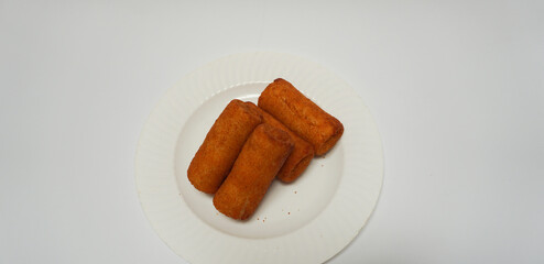 Risoles, traditional snack form Indonesia. It filled with carrot, potato, chicken and other vegetables rolled in breadcrumbs then deep fried in a plate on white background.