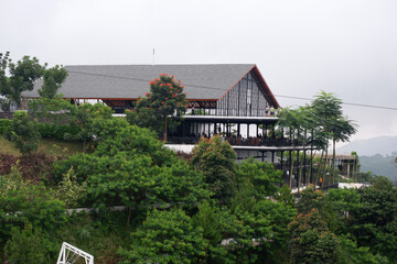 modern building on the edge of the mountain with a green natural surrounding