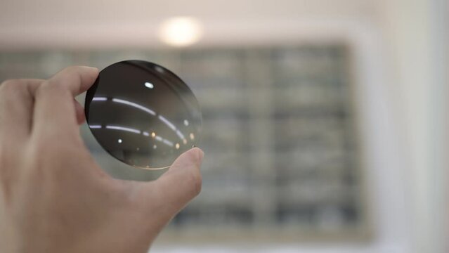 person with sunglasses lenses in optical store 