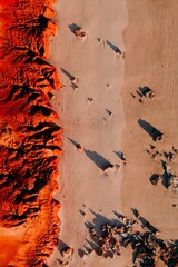 Abstract aerial perspective capturing an orange sandy beach with red rocky cliffs Kimberley Western...