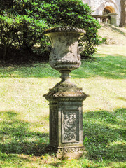 Decorative stone flowerpot on a pedestal in the palace courtyard in Konopiste Castle in Czech Republic