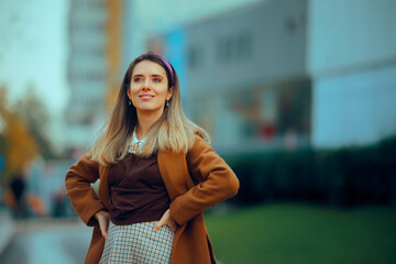 Trendy Fashionable Urban Woman Standing Outdoors. Pretty lady wearing stylish earth tone clothing 
