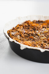 plant-based lentil and pumpkin pie with filling just poured into the pastry before cooking it