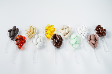 Various vitamin and mineral pills, food supplement health product in transparent spoon
