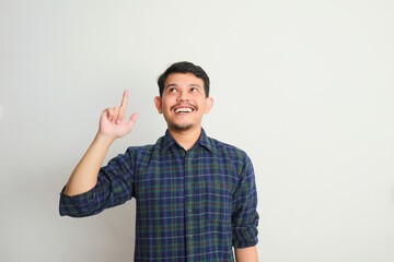 an asian man smiles and points to something with his hand, advertising concepts