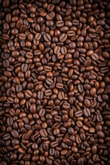 Fototapeta premium Overhead view of backdrop representing halves of dark brown coffee beans with pleasant scent