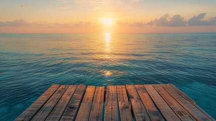 Rustic wooden podium with the sun rising over a tranquil, crystal-clear ocean