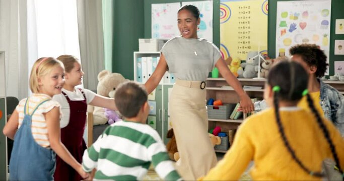 Teacher, children and dancing in circle, fun and happiness with education, game and break. Group, educator and woman with kids, movement or development with joy, cheerful or youth with music or smile
