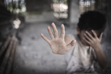 Boy showing hand signaling to stop useful to campaign against violence and pain. Stop abusing boy violence.  Human Rights Day concept.