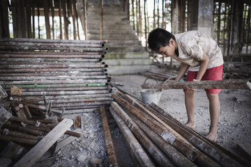 Poor children are forced to work in construction. Child labor in building commercial building...