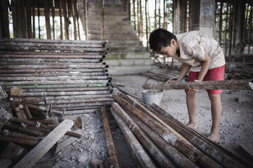 Poor children are forced to work in construction. Child labor in building commercial building structures. World Labor Day concept.