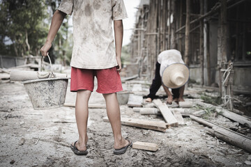  Poor children are forced to work in construction. are forced to work in the construction area. Human rights concepts, stopping child abuse, violence, fear of child labor and human trafficking.