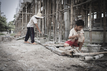 Two poor children are forced to work in construction. Poor children, poverty, Child labor, World...