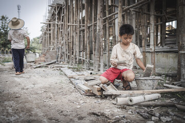 Two poor children are forced to work in construction. Poor children, poverty, Child labor, World Day Against Child Labour concept.