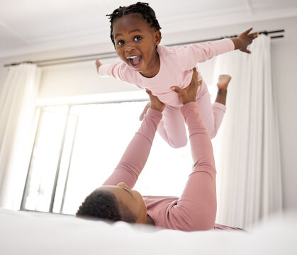 Bedroom, morning and mother playing with daughter in bed of home together for bonding. Black family, kids and love with african woman, girl and child fun together in house for waking up on weekend