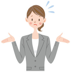 困った表情のグレーのスーツの女性　お手上げ　