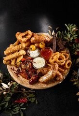 Assorted Pub Snacks for Beer - Toasts, Sausages, Fried Calamari, Onion Rings, Buffalo Wings on...