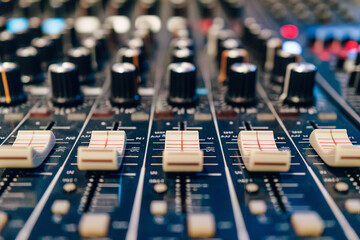 Audio mixing console with rotary controls, sliders, and buttons
