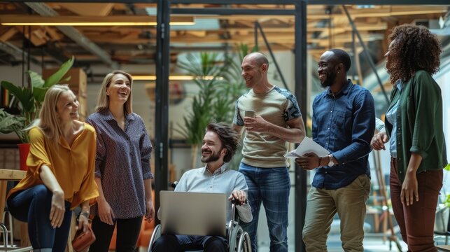 A group of diverse professionals in business-casual clothing are gathered in a modern office space. AIG535
