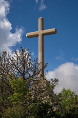 Big cross made of stone on the top of the mountain