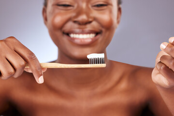 Toothpaste, bamboo brush and woman in studio with oral care, health and wellness routine for self...