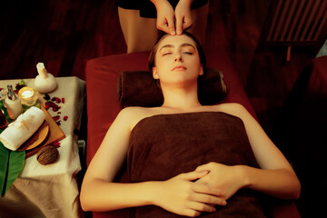 Caucasian woman enjoying relaxing anti-stress head massage and pampering facial beauty skin...