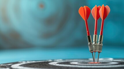 Fototapeta premium three red darts hitting the bullseye of a dartboard on a blurry blue background