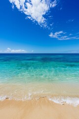 Obraz premium Clear blue sky and turquoise sea at a sandy beach