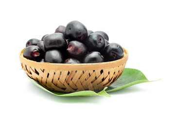A wooden basket filled with 'Indian blackberry' or Jamun (Syzygium cumini) fresh fruits. Isolated on a white background. Front view.