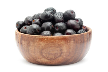 A wooden bowl filled with 'Indian blackberry' or Jamun (Syzygium cumini) fresh fruit. Isolated on a white background. Front view.
