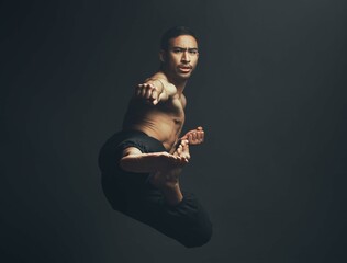 Martial arts, kick and man in portrait, training and fitness for wellbeing in studio backdrop for...
